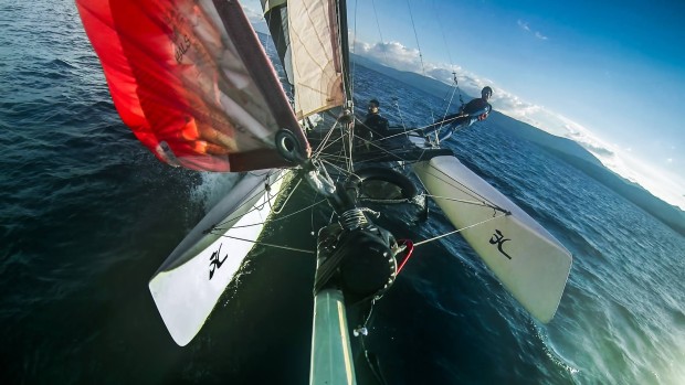 Flying hull with the spinnaker up, fun evening on the lake! JT Holmes on the trapeze.