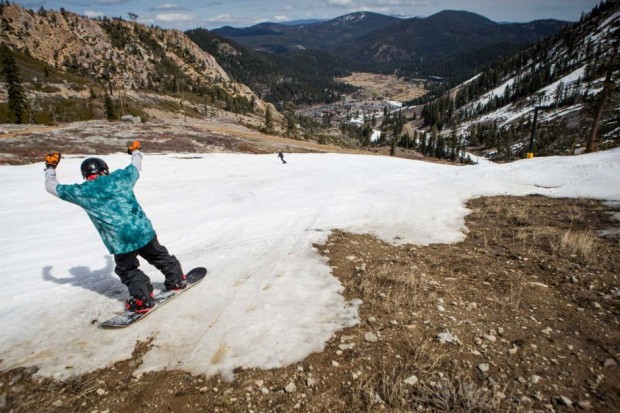 A snowboarder threads his way through patches of dirt at Squaw Valley Ski Resort (www.sfgate.com)