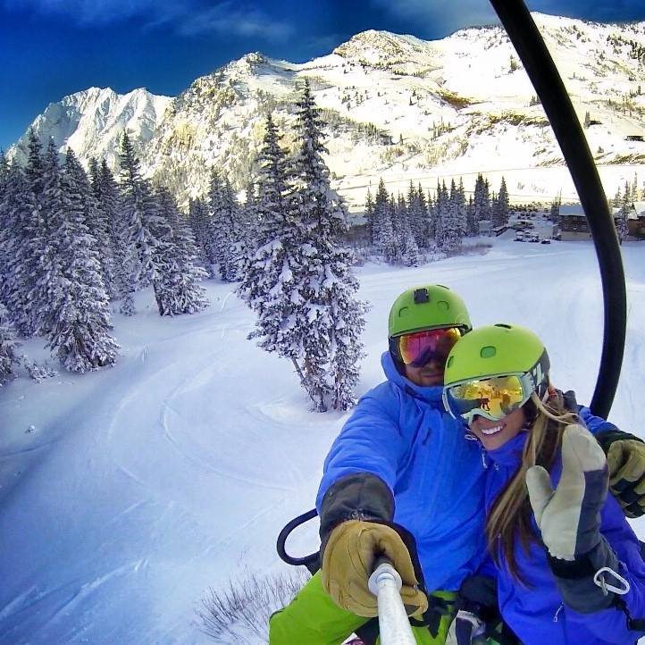 A couple wearing green and blue matching outfits.