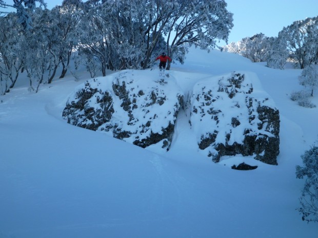 Joe cliff hucking in front of the lodge.
