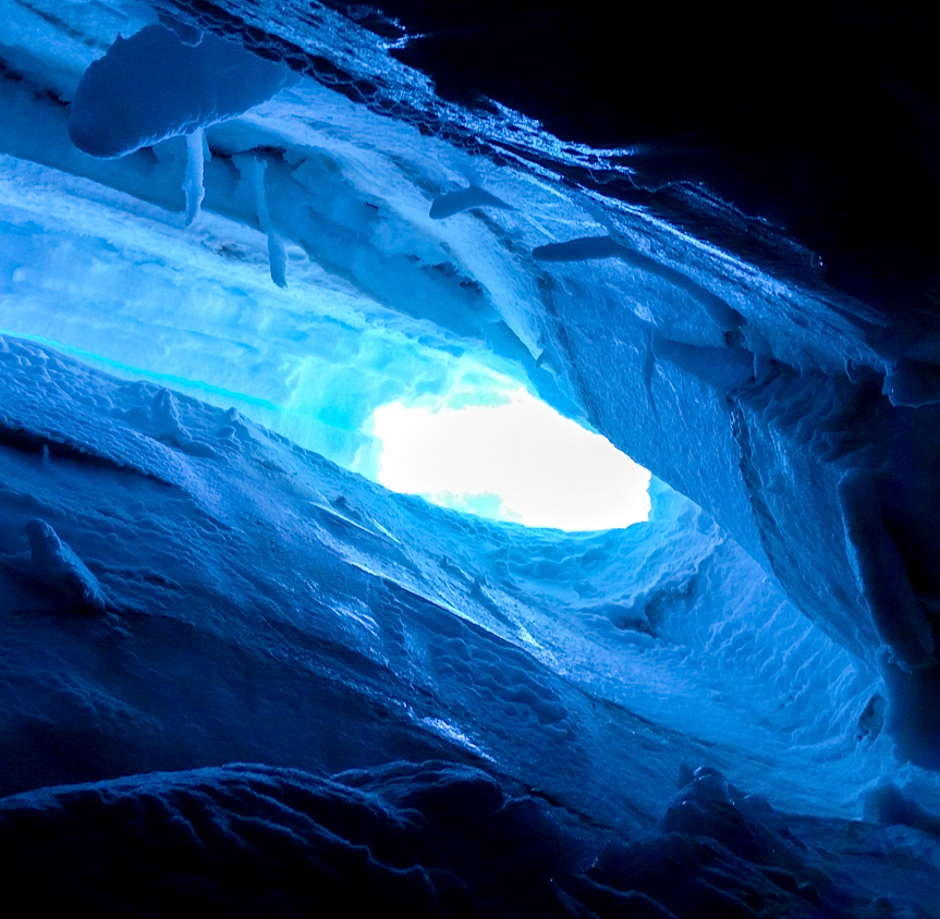 Looking up from my resting place on the snowbridge at the hole I fell into and the ice I slid down