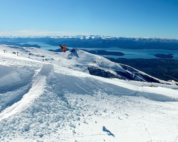 Drone image of a snowboarder throwing an alley-oop today.
