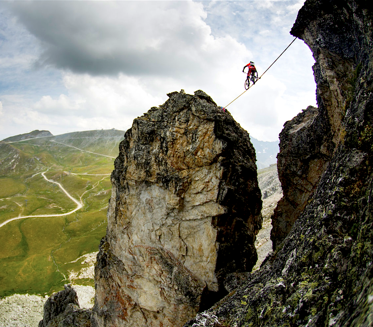 Kenny Belaey slacklining on a mountain bike.