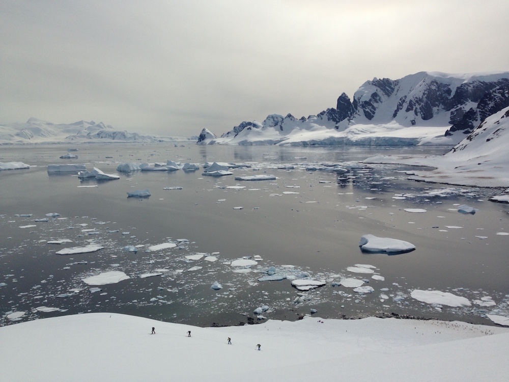 Glassy seas, skiers, and icebergs. image: miles clark