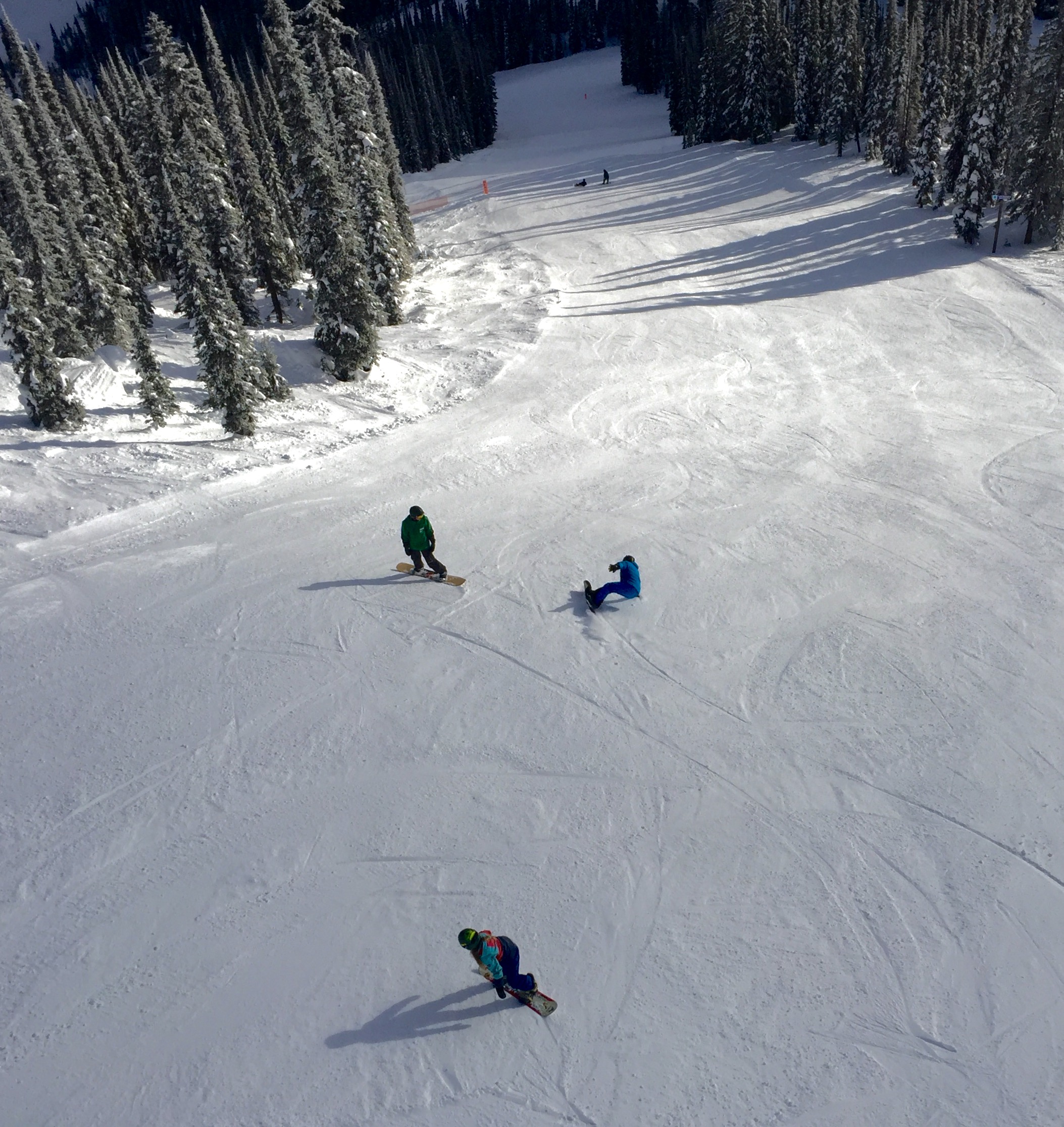 This snowboarder was laying it over on the crisp groomers.