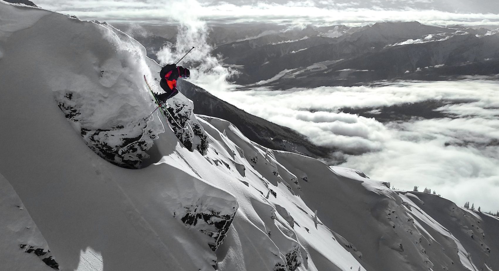 Miles Clark jumping off cliff into couloir