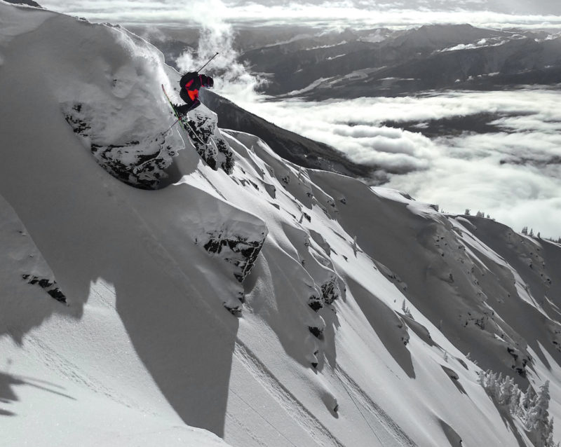 Miles Clark jumping off cliff into couloir