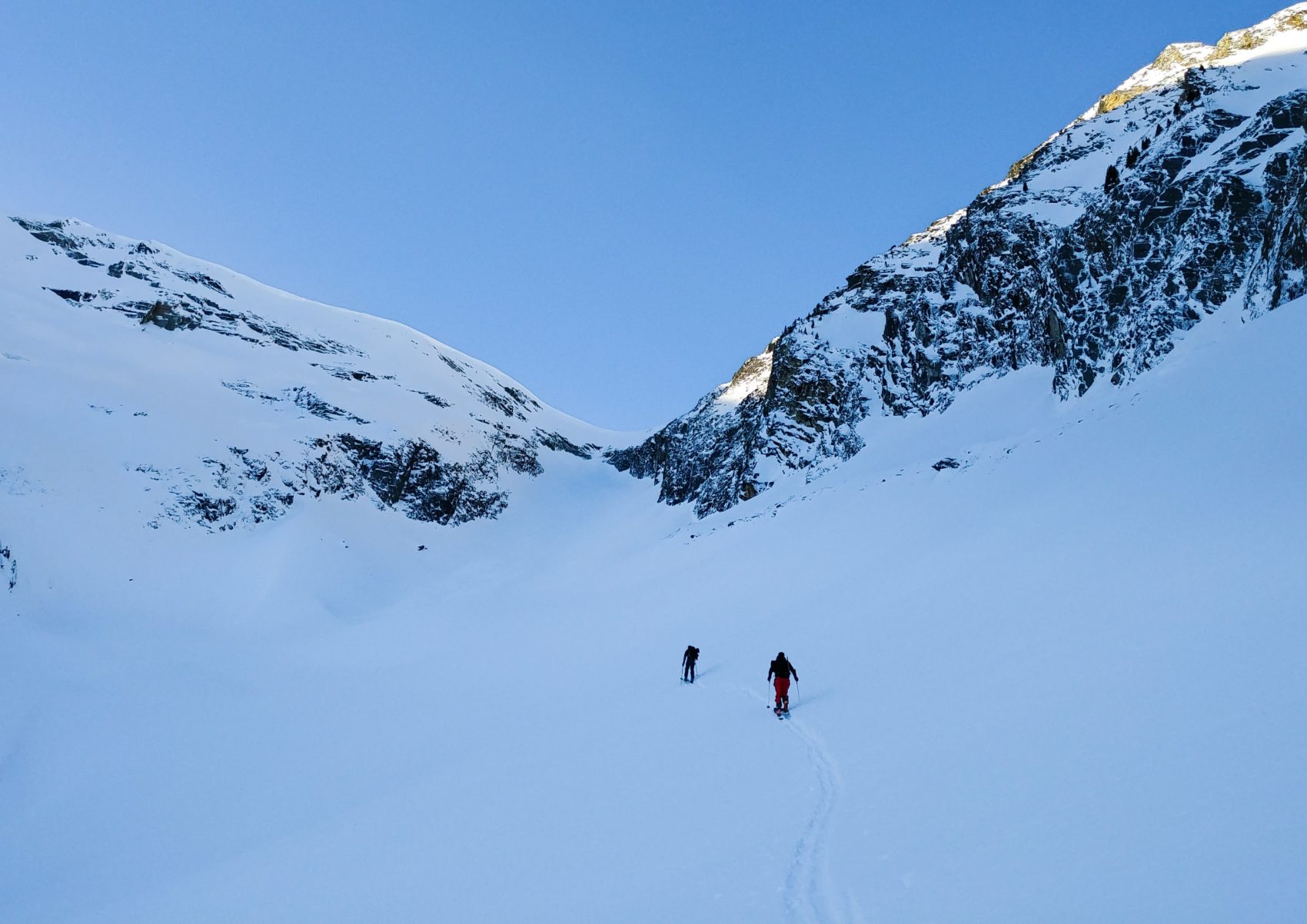 skier sprinting out of exposed valley