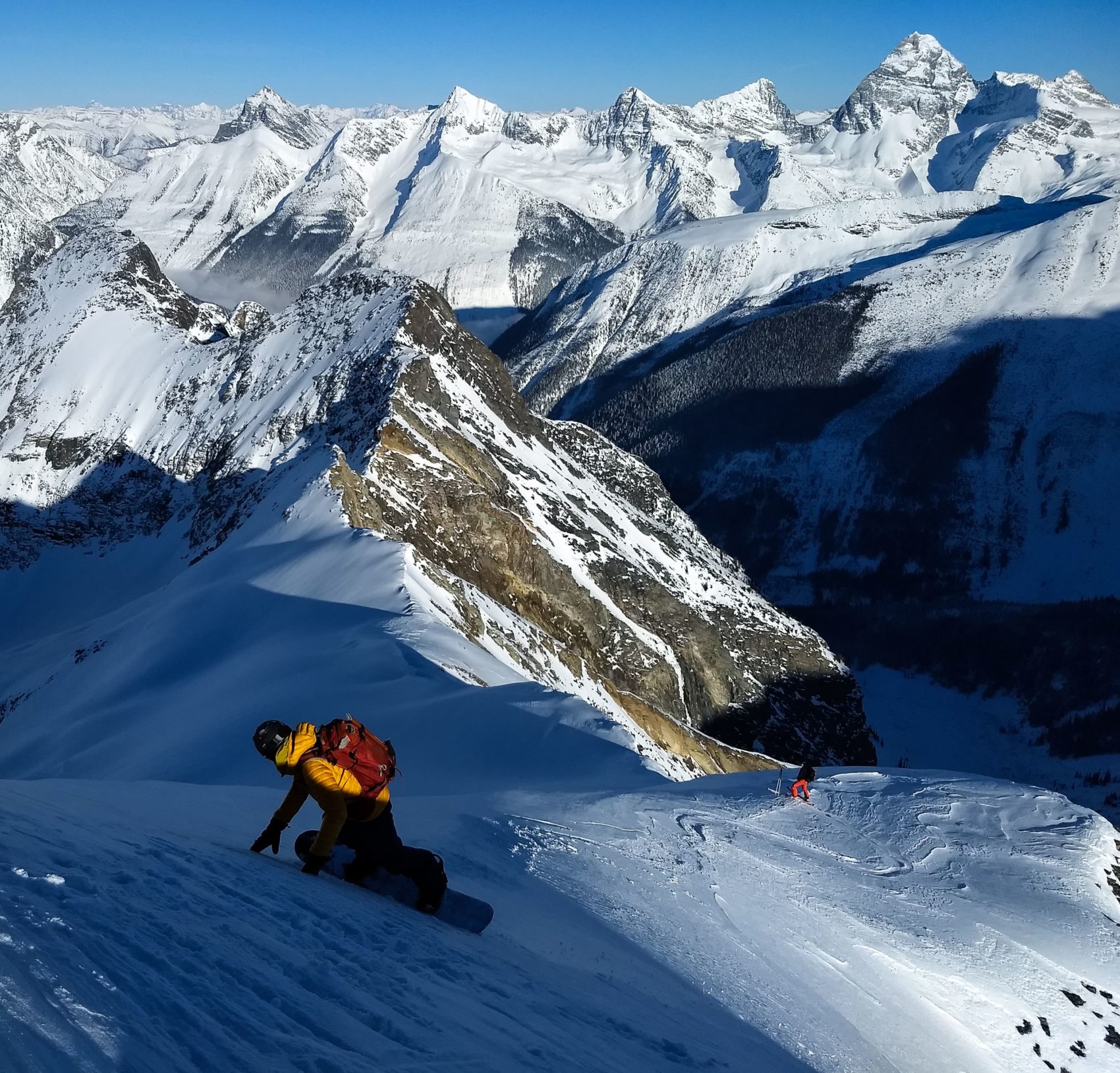 snowboarder sliding down exposed face