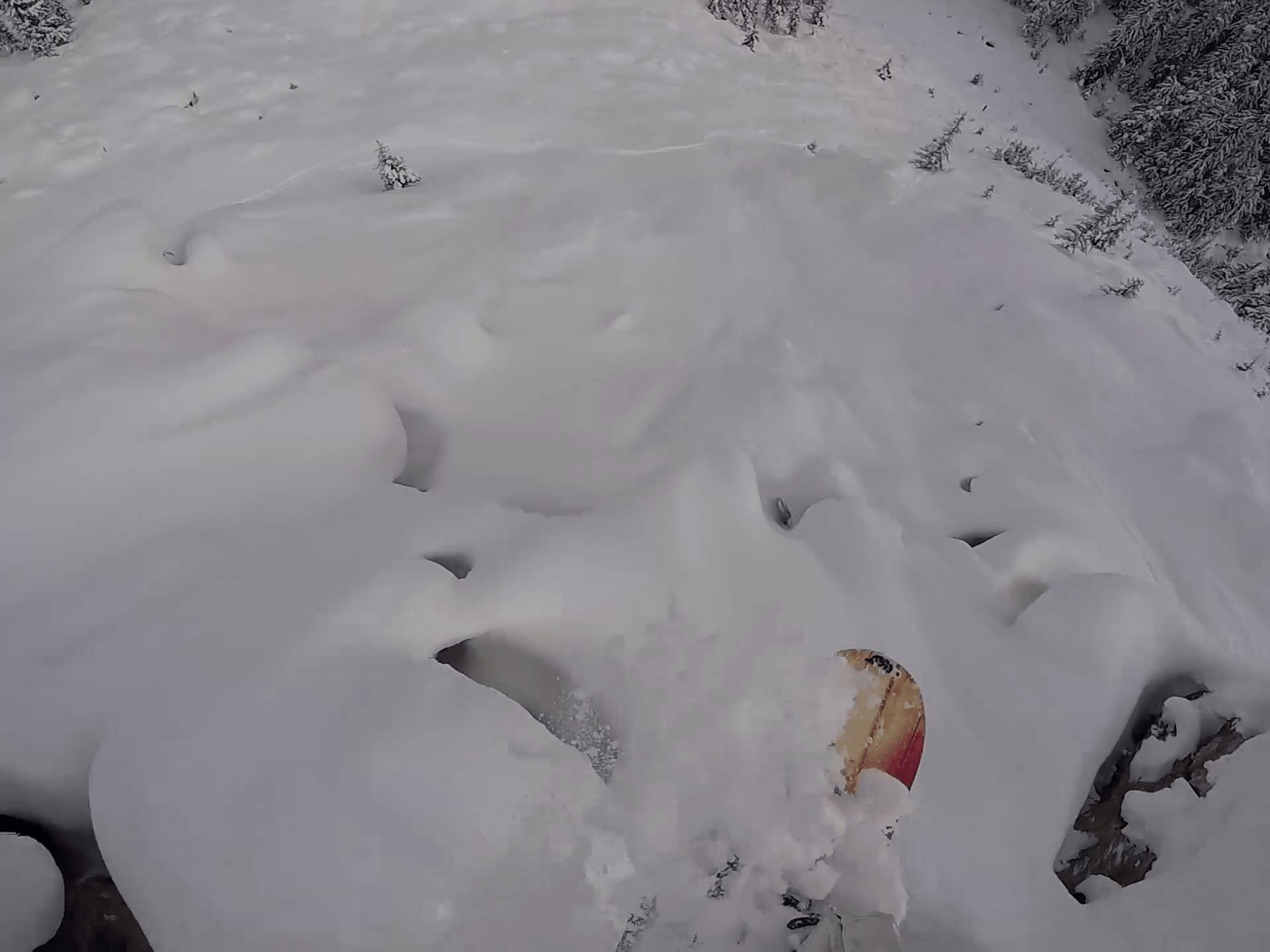 snowboarder flying over pillow line