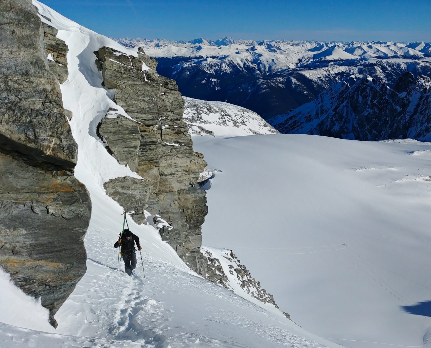 skier bootpacking up rogers col