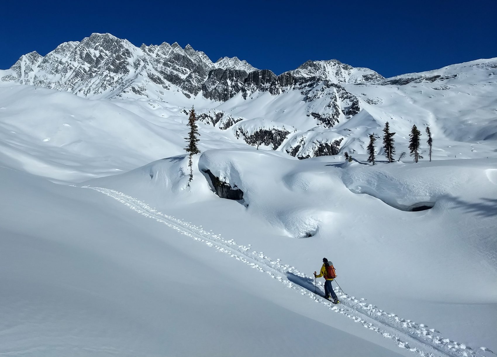 splitboarder heading up rogers peak