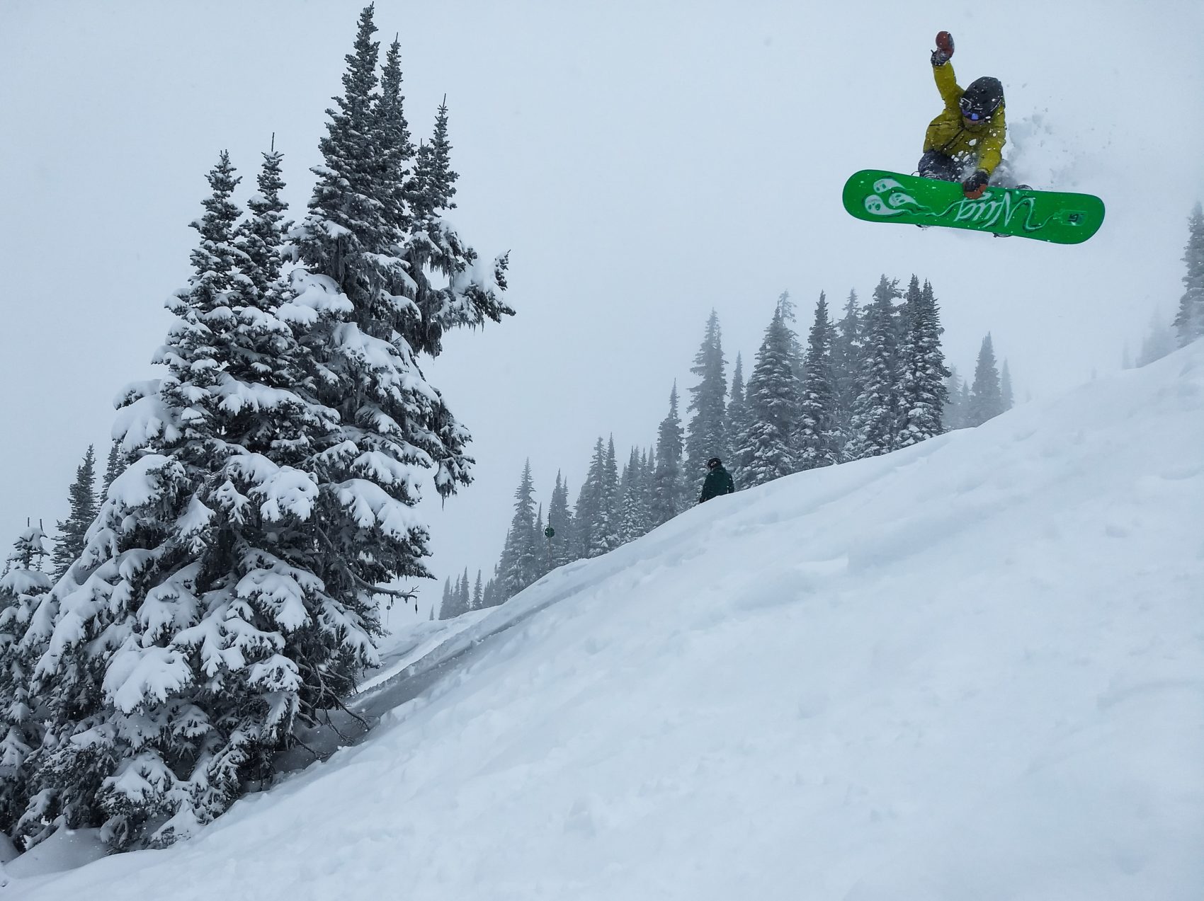 snowboarder with Burton board jumping off a run