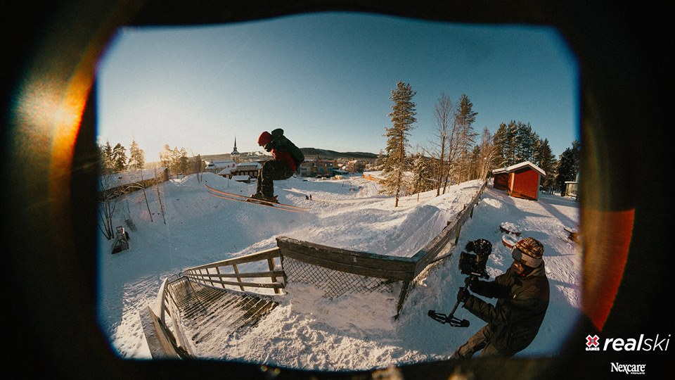 skier jumping into a rail filming for x games real videos