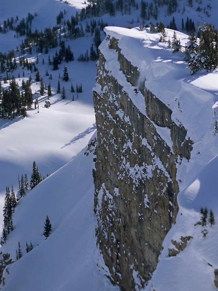 Cliff jump ski snow powder ski send BASE jump