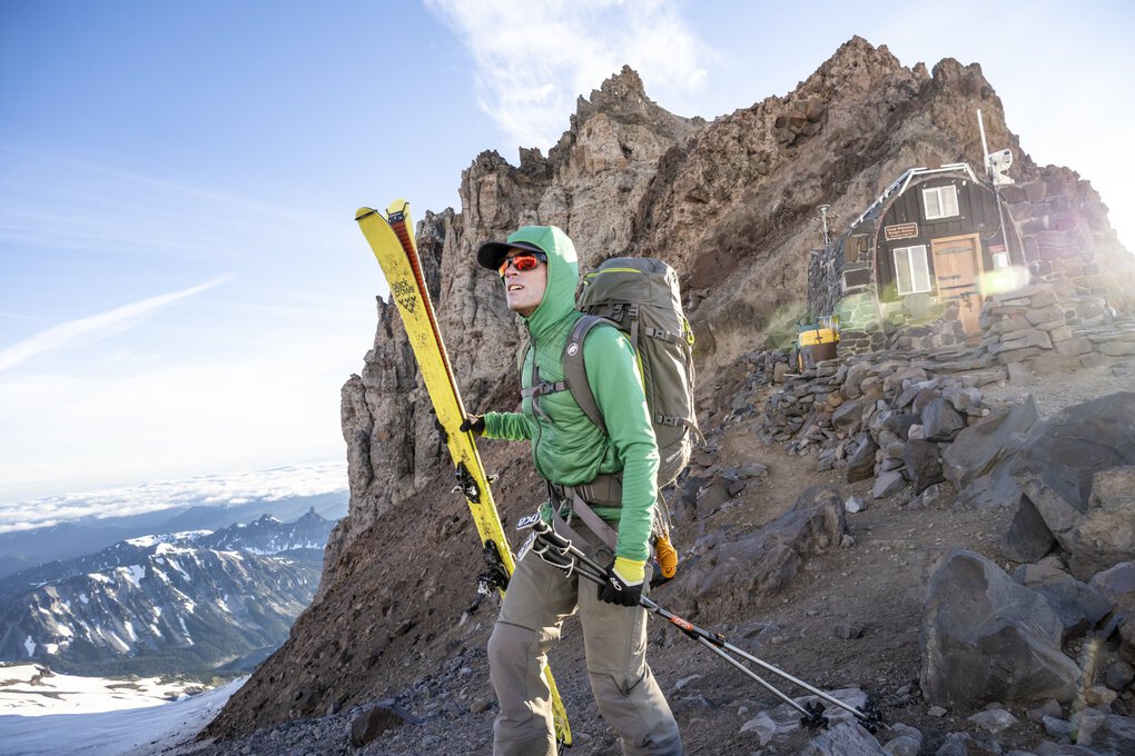 Climber on mountain with skis