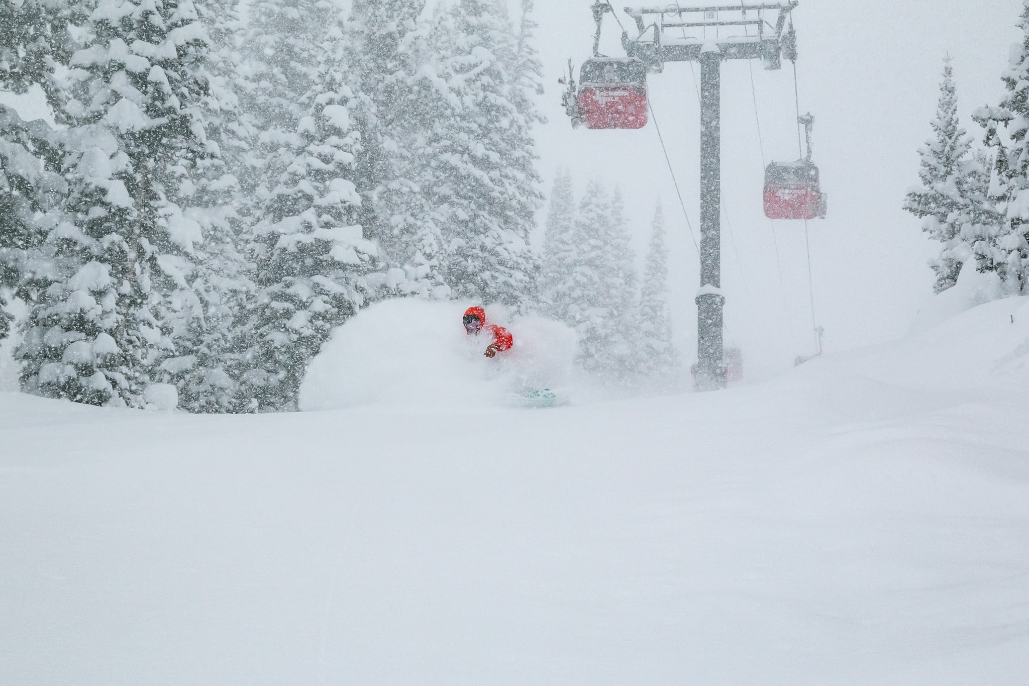 Snowboarder Riding Beneath Gondola