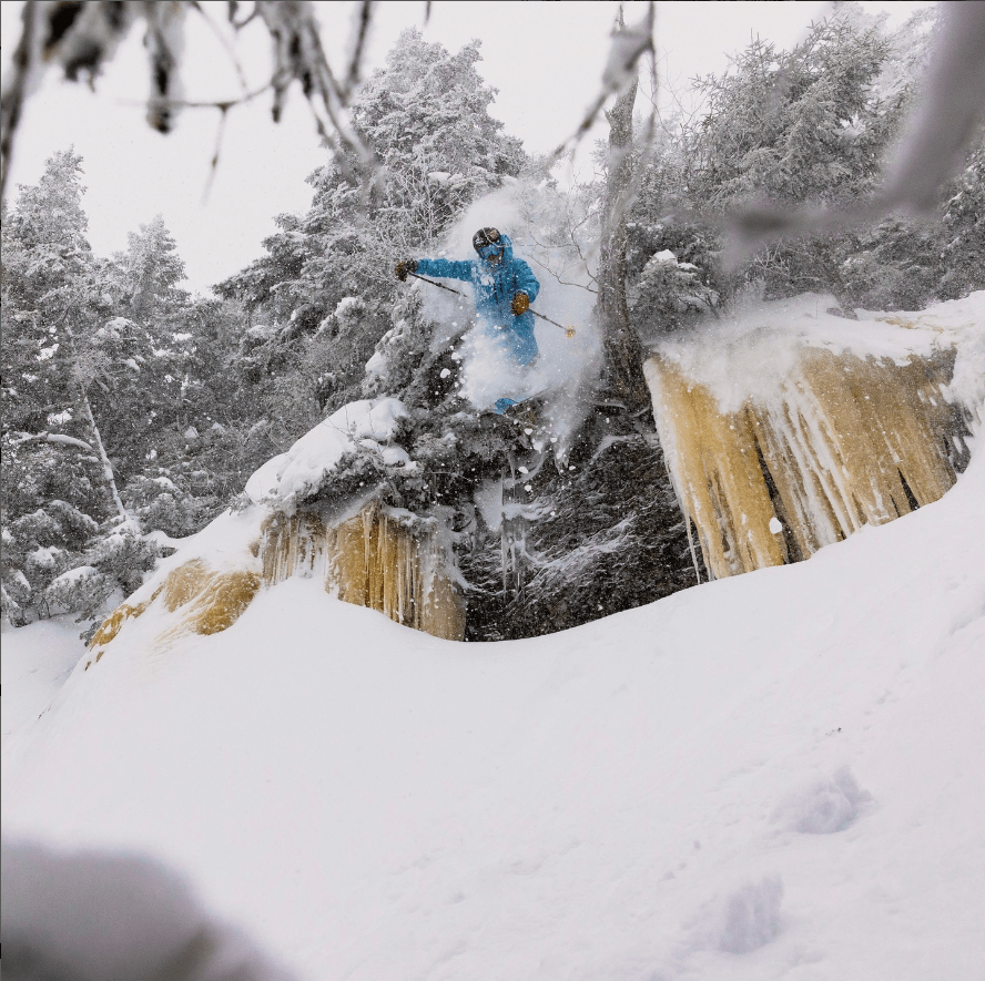Skier jumps cliff into powder at Mad River Glen