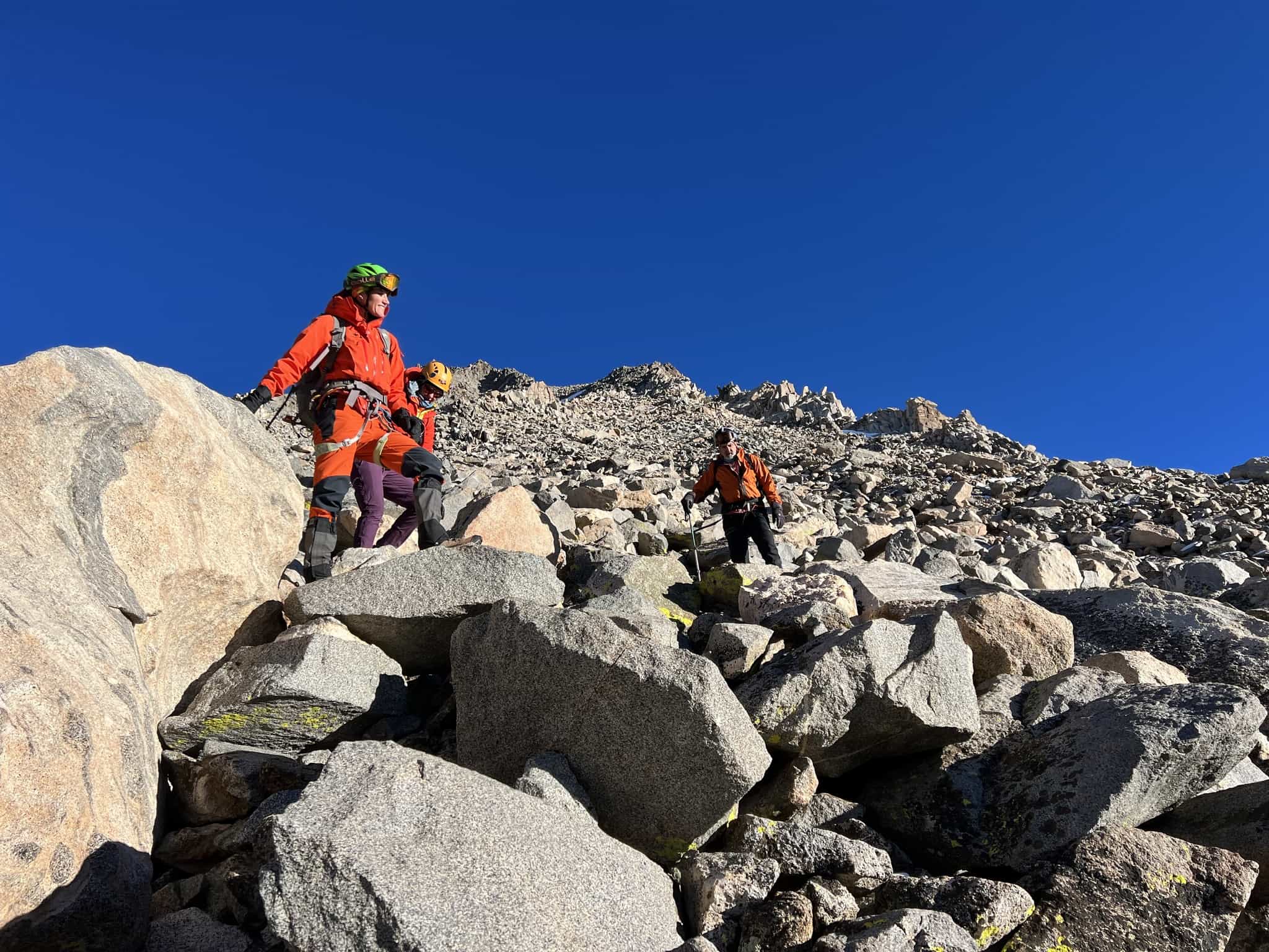 mountain rescue teams searching in rugged rocky terrain