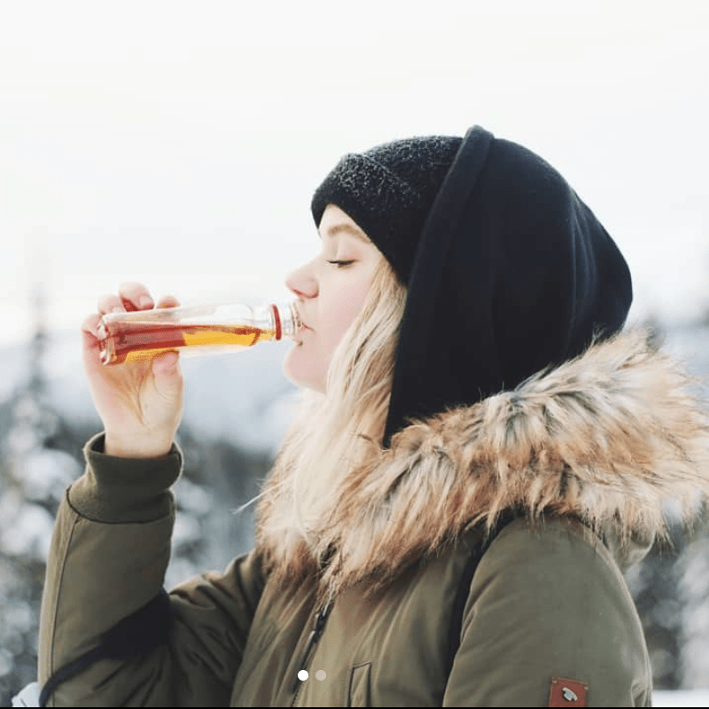 Skier drinking Fireball while skiing