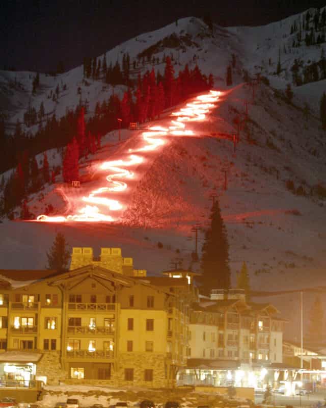 A torchlight parade coming down the mountain at Palisades Tahoe 