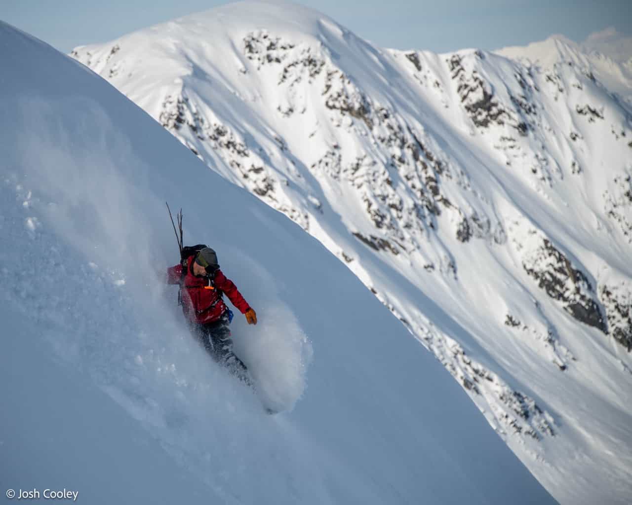 snowboarder on steep mountain in deep snow with pulseline adventure