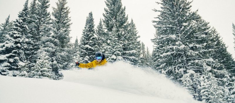 Skier shredding powder off Grouse Mountain