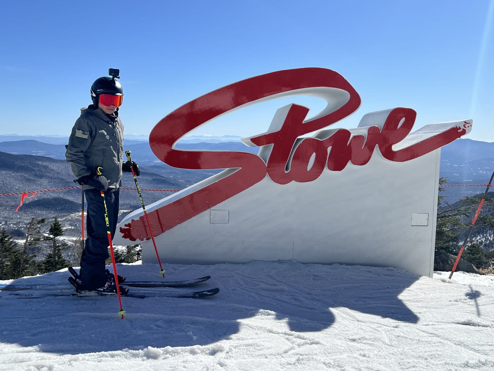 Skier in front of sign at Vail Resorts Stowe Mountain resort