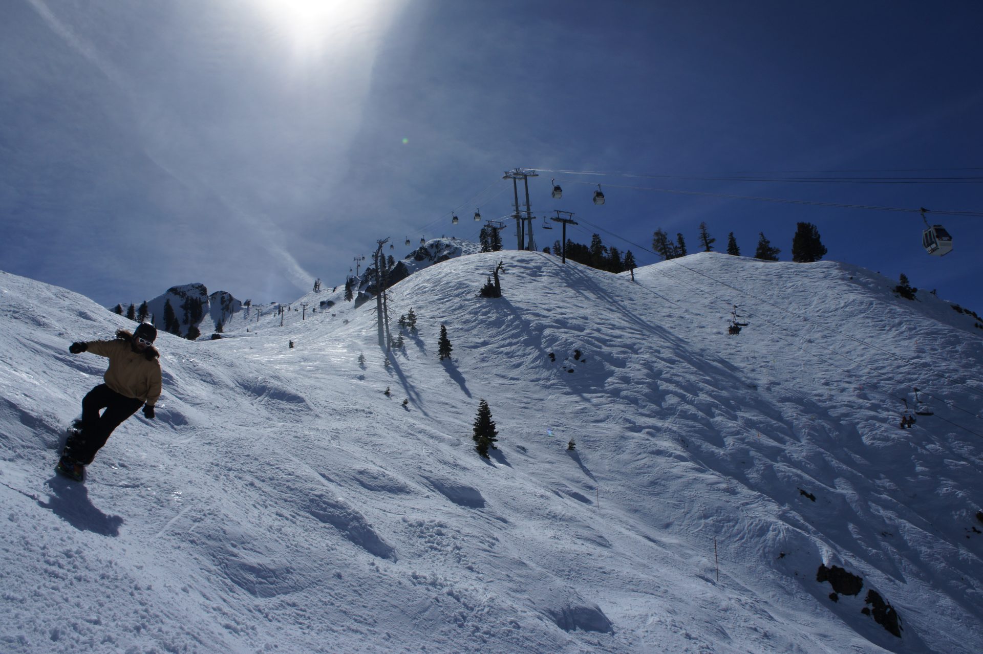 snowboarder in the moguls at palisades tahoe