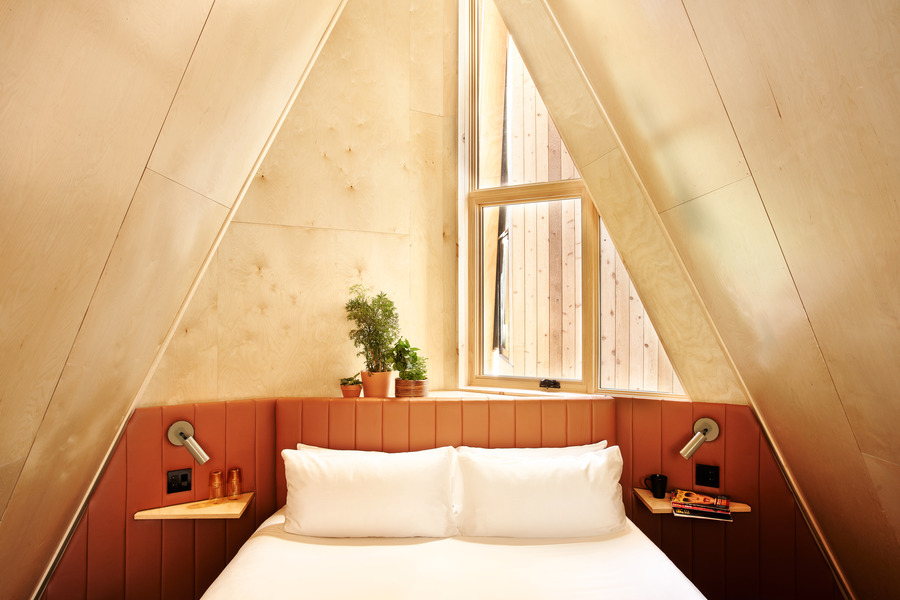 The loft-style bed. Photo Credit: A-Frame Club