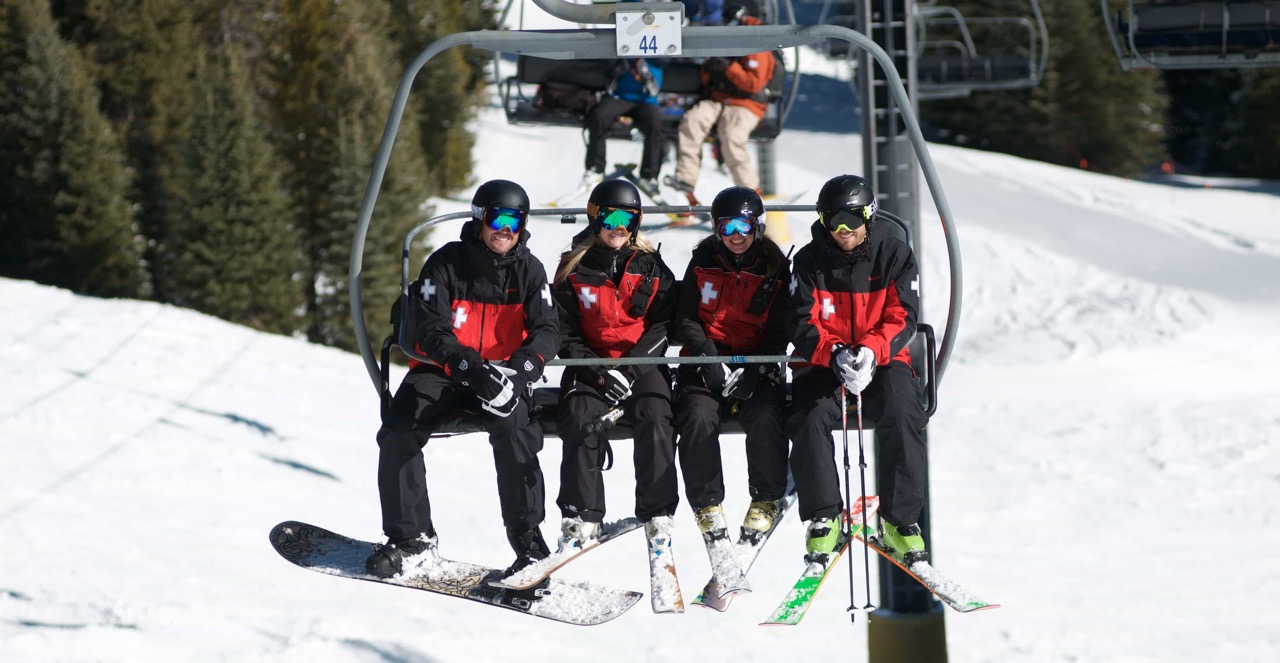 Ski patrollers on a chairlift