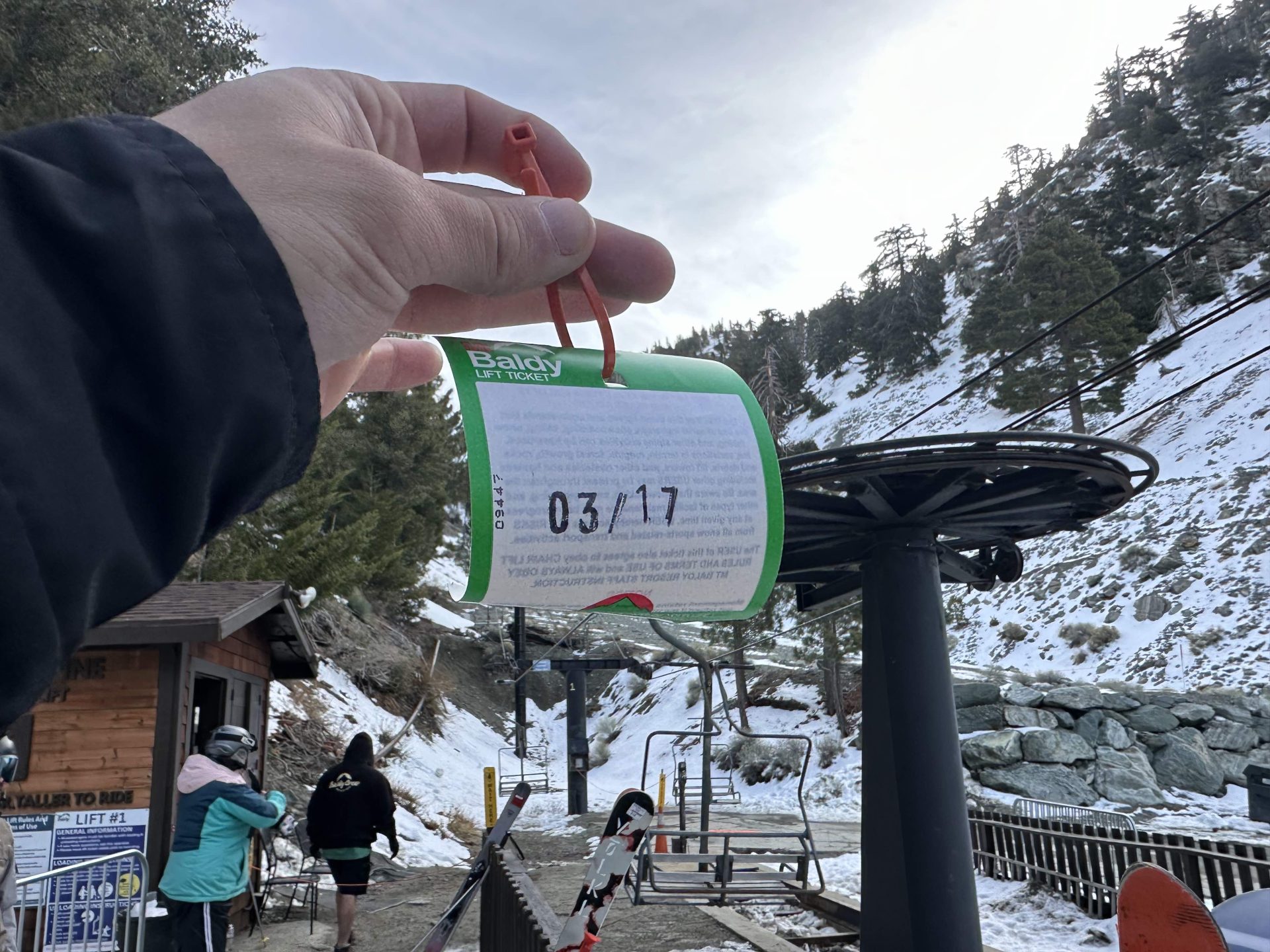 Skier holds paper lift ticket at Mt Baldy